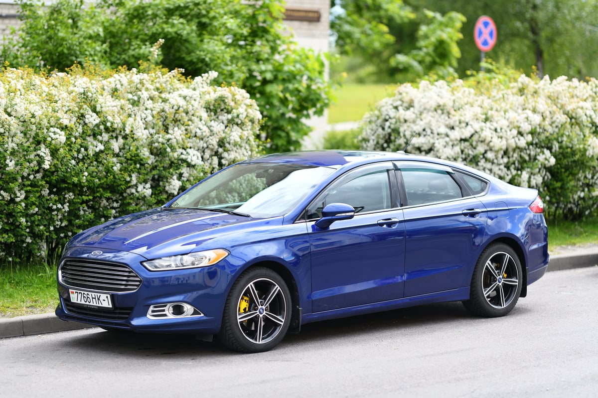 Blue Ford Fusion sedan parked on street